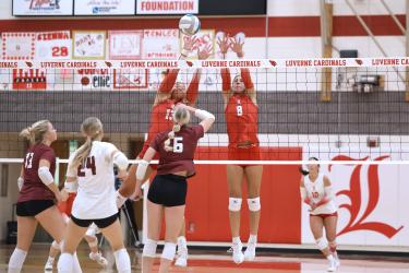 Greg Hoogeveen photo/LHSVB1 LHS senior Lexi Braun, No. 13, and sophomore Delaney Ahrendt, No. 8, jump to block a Fairmont spike Oct. 13 in Luverne. The Luverne Cardinals fell 3-0 to Fairmont at home.