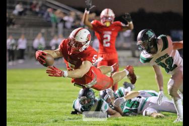 Greg Hoogeveen photo/1008LHSFB1 Cardinals senior Matthew Gangestad leaps into the end zone after breaking through three Pipestone players at the 3-yard line for a LHS touchdown. Luverne beat Pipestone 42-0 Friday, Oct. 2, at home in the annual Battle Axe contest.