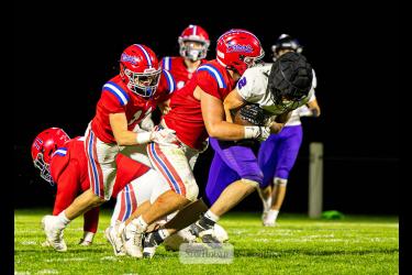 Samantha McGaffee photo/1008HBFB1 H-BC junior Karson Metzger wraps up a Mustangs player with the ball Friday, Oct. 2, on the road. THe Patriots beat GHECT 58-0 in the game.