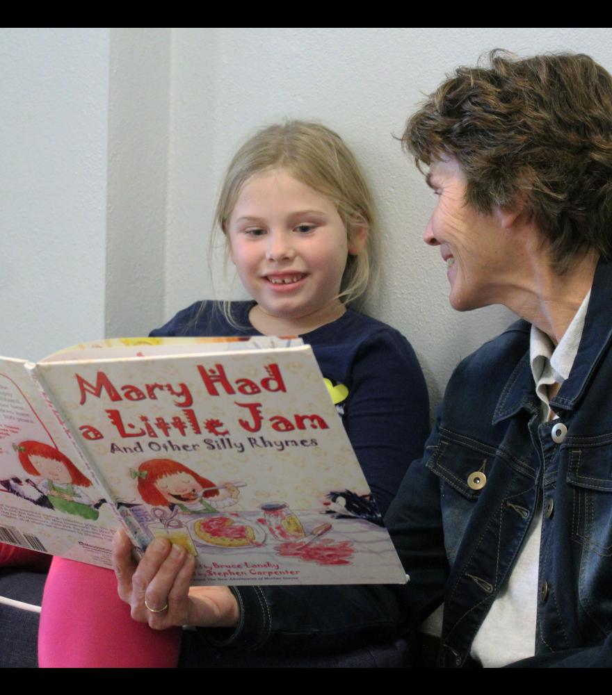 Anna Beyer (left) smiles as she reads “Mary had a Little Jam and Other Silly Rhymes” with Lisa Lundgren. The two are part of the Grace Reading Buddies program recently started by current and retired members of Grace Lutheran Church.